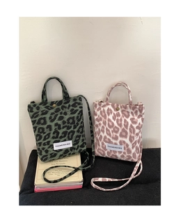 Detail of leopard print canvas mini tote bags with top handle and crossbody strap