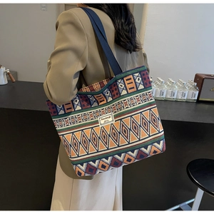 Detail shot of bohemian canvas tote bag with colorful geometric patterns and shoulder strap
