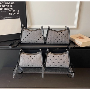 Detail view of four grey knitted underarm bags featuring polka dots and bow patterns