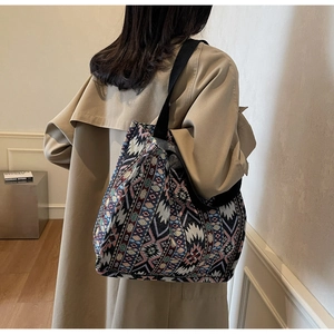 Close-up of ethnic jacquard tote bag with geometric patterns and canvas shoulder strap