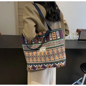 Detail of large canvas tote bag with colorful ethnic geometric patterns and strap