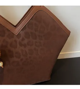 Detail of vintage leopard print tote bag with soft suede texture and leather piping