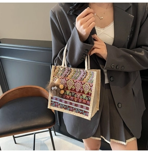 Ethnic embroidered tote bag detail with colorful patterns and a plush monster charm
