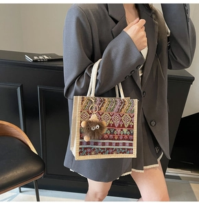 Detail of ethnic woven fabric tote bag with tassel charm and cotton rope handle