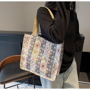 Detailed close-up of bohemian jacquard tote bag with geometric star patterns on strap