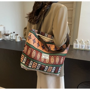Detail of vintage geometric canvas tote bag with woven shoulder strap and logo label