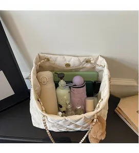 Large capacity white quilted tote bag interior view with water bottle and umbrella