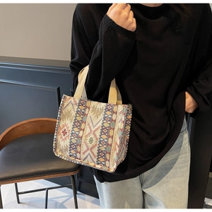 Detailed side view of an ethnic woven jacquard tote bag with geometric patterns