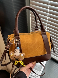 Retro mustard yellow matte patchwork pillow bag with brown leather handles and bear charm