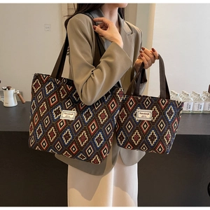 Detail of bohemian geometric canvas bucket bag set with brown woven handles