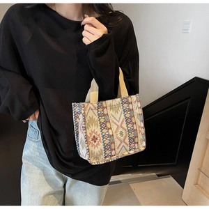 Detailed view of ethnic woven tote bag with geometric tapestry patterns and sturdy handles