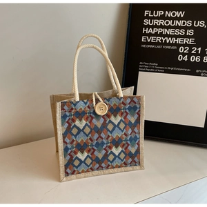 Detail of woven linen handbag with colorful geometric diamond patterns and rope handle
