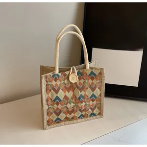 Detail of woven geometric diamond pattern linen handbag with rustic wooden button