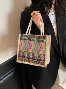 Ethnic style jute tote bag with colorful geometric woven patterns and rope handles