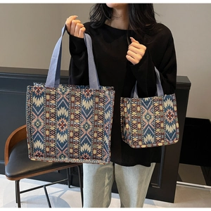 Comparison of large and small ethnic tote bags with geometric star patterns and woven straps