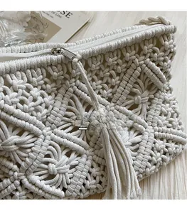 Detailed macro shot of handmade macrame envelope bag with fringe zipper and cotton weave