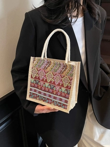Ethnic bohemian woven tote bag with vintage jacquard pattern shown on a female model