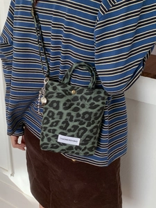 Army green leopard print canvas crossbody bag with top handle and heart charm detail