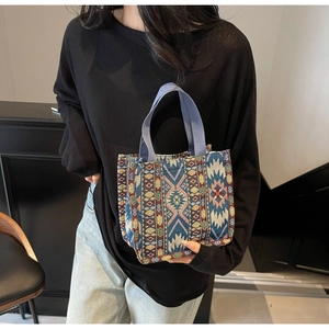 Close-up of geometric ethnic pattern weaving on a large canvas tote bag for women