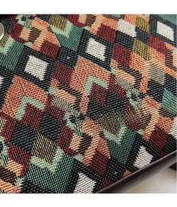 Macro shot of colorful geometric woven fabric with ethnic embroidery textures