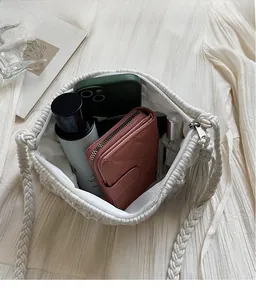 Top view of woven shoulder bag showing large interior capacity for phone and wallet