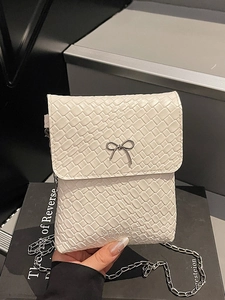 Women's cream white underarm bag with silver bow accent and woven texture detail