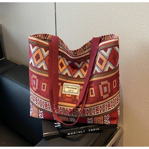 Detailed close-up of vintage red jacquard tote bag featuring ethnic geometric patterns