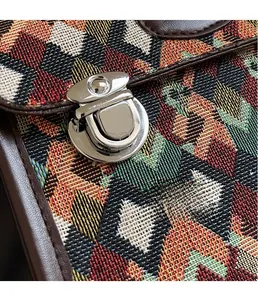 Close-up of bright silver metal buckle and colorful geometric quilted fabric detail