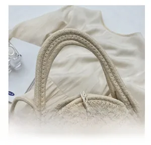 Close-up of straw woven tote with lace trim, wood button, and thick comfortable handles