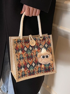 Linen tote bag with geometric diamond pattern, wooden button, and plush charm detail