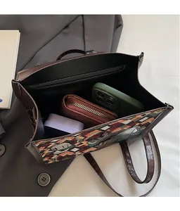 Interior view of geometric tote bag showing spacious capacity for wallet and phone