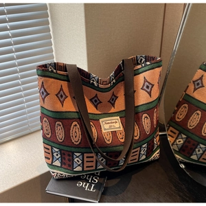Detail of woven tote bag featuring ethnic geometric patterns and vintage fabric label