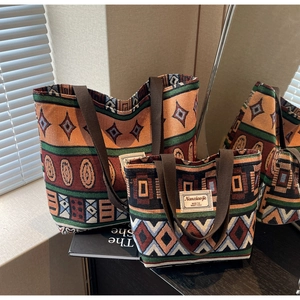 Detail of two-piece canvas tote set featuring geometric ethnic patterns and durable handles