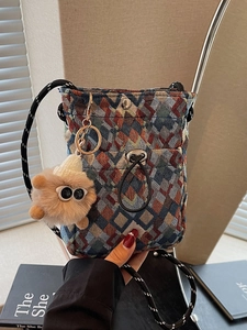 Bohemian woven crossbody bag with geometric jacquard pattern and cute plush charm