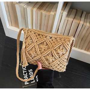 Detail of hand-woven bohemian crossbody bag with intricate fringe and tassel texture