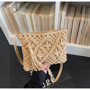 Detailed view of bohemian hand-woven bag featuring diamond patterns and long tassels
