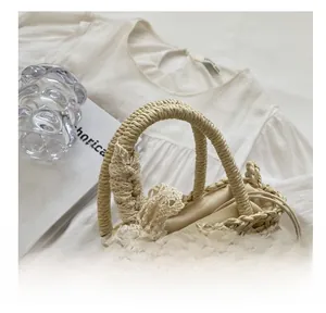 Detail of straw woven beach bag with lace bow, daisy applique and drawstring lining