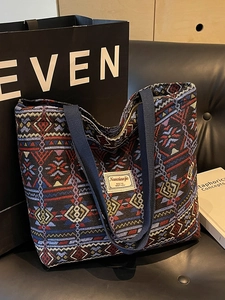 Large woven tote bag with ethnic geometric patterns and durable canvas webbing handles