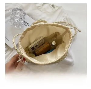 Top view showing the spacious interior and drawstring lining of this straw bucket bag