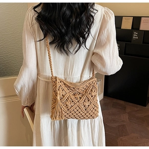 Detail of bohemian handmade woven shoulder bag with khaki fringe and hollow mesh pattern