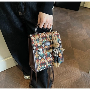 Detail of vintage geometric jacquard handbag with brown leather trim and bunny charm