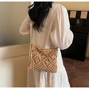Detail of handmade macrame straw bag with long fringes and geometric woven patterns