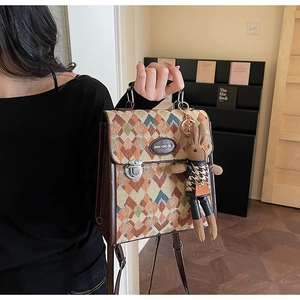 Macro detail of retro quilted texture bag with leather trim and rabbit plush charm