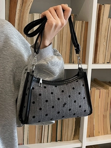 Polka dot underarm bag in grey wool with black bow detail and leather shoulder strap