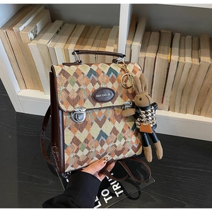 Detail of geometric woven texture and leather trim on a retro women's backpack