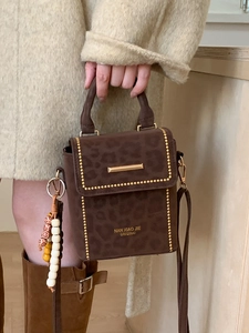 Brown leopard print crossbody bag with gold bead trim and bead pendant charm