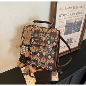 Detailed close-up of quilted jacquard backpack with leather handle and rabbit charm