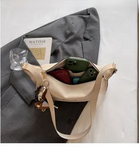 Interior view showing large storage capacity of the beige hobo bag with personal items