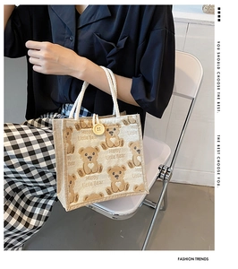 Close-up of cute bear canvas lunch bag featuring wood button and soft cotton rope handle