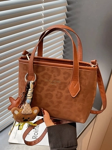 Brown leopard texture tote bag with star and bear charms for casual commuting